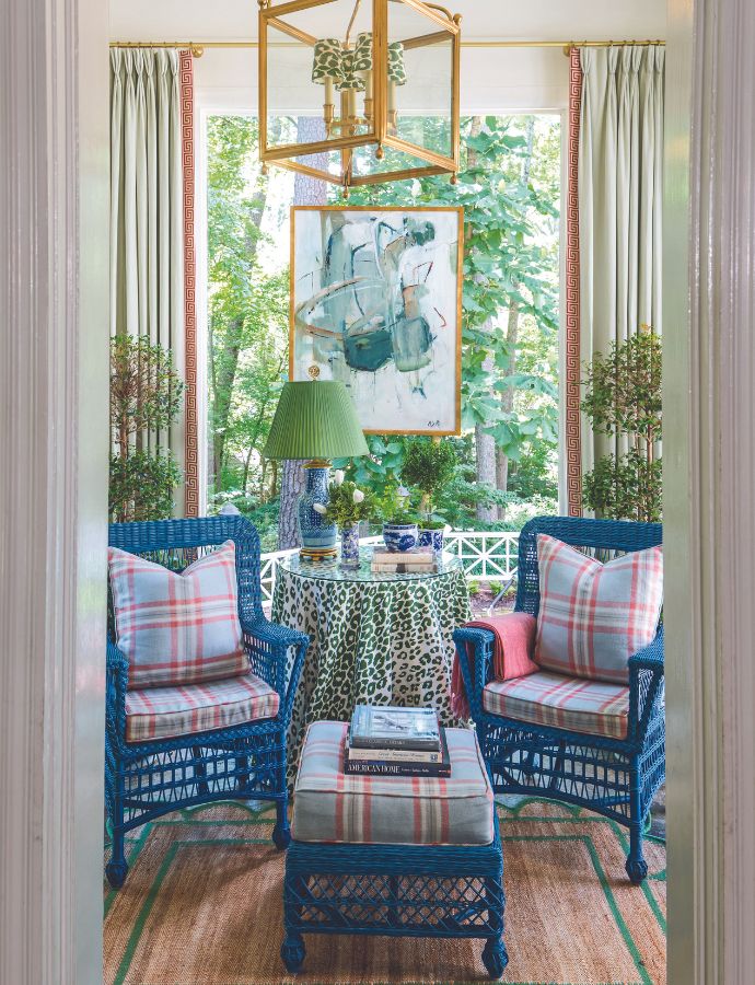 A sunroom with blue wiker chairs