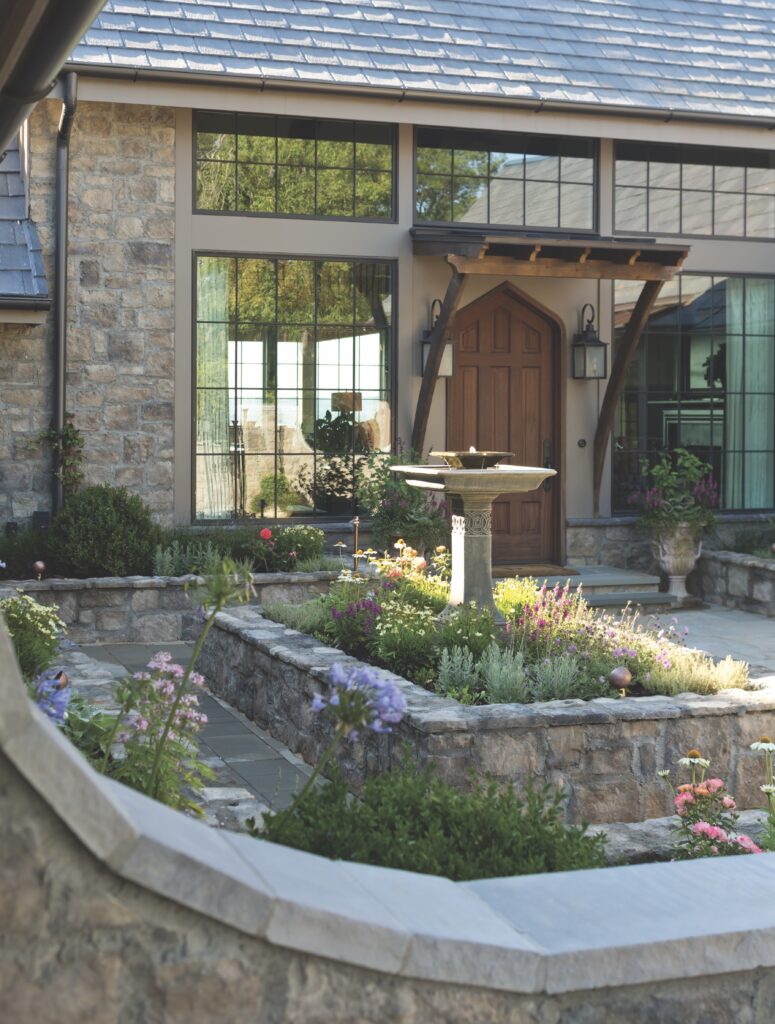 Front entryway with fountain and flowers