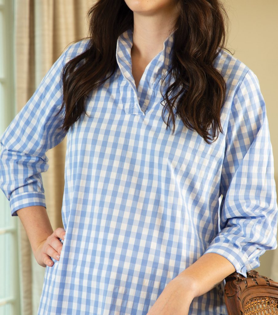 Brunette woman in a blue-and-white checked tunic