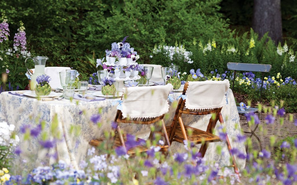 Garden table setting with purple flowers