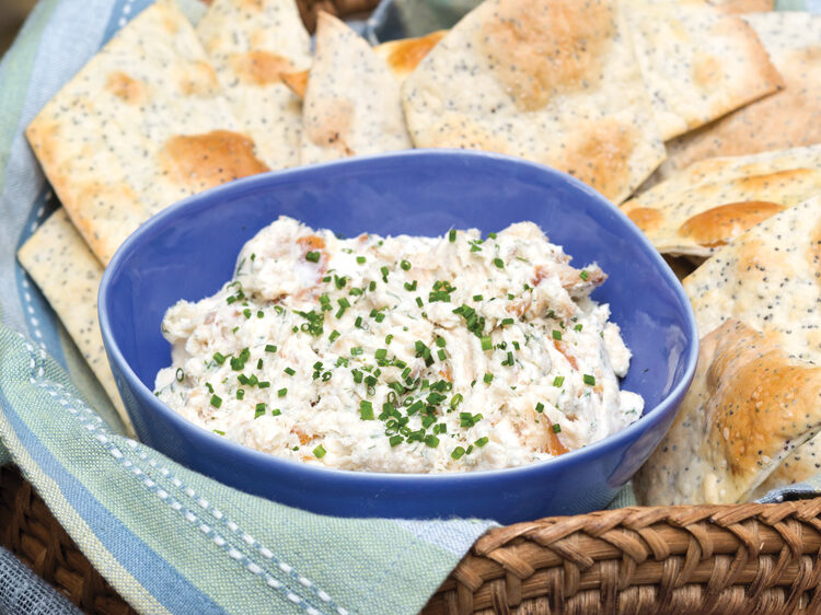 Smoked Trout Dip in a blue bowl with crackers