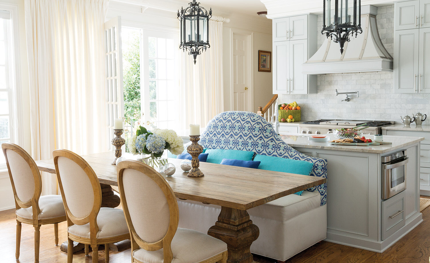 White kitchen with blue upholstered bench