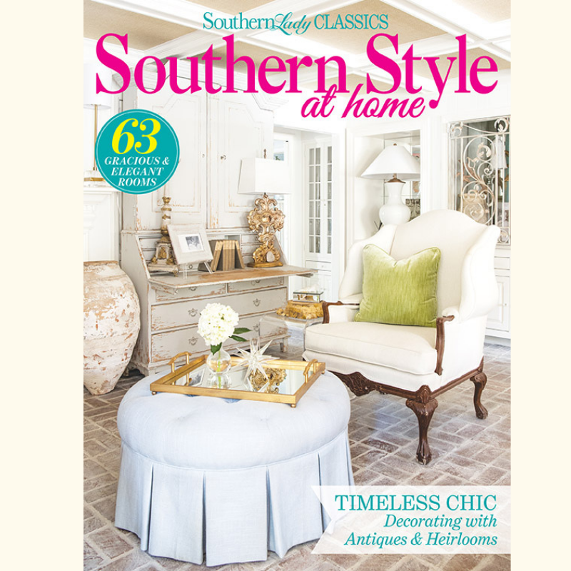 Magazine cover for Southern Style at Home showcasing a vintage, chic living room with a white armchair, pastel blue ottoman, and ornate furniture in a sunlit space