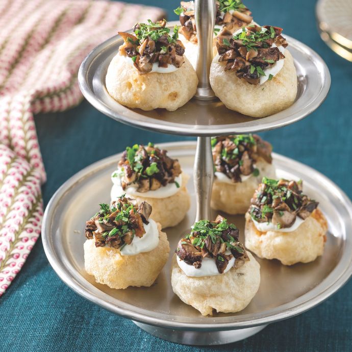 Risotto cakes with roasted mushroom caviar on a silver stand