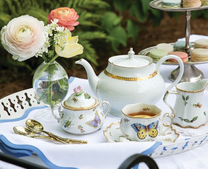 Nature-motif tea service on a tray with flowers