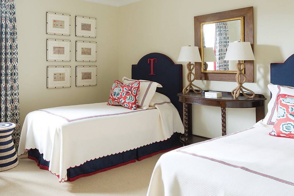 Twin beds with monogrammed 'T' on navy headboards