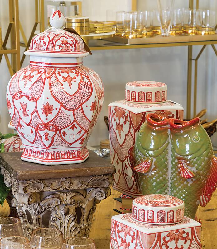 Orange-and-white ginger jars, glassware, and green ceramic fish decor at Howard & Marsh Exchange