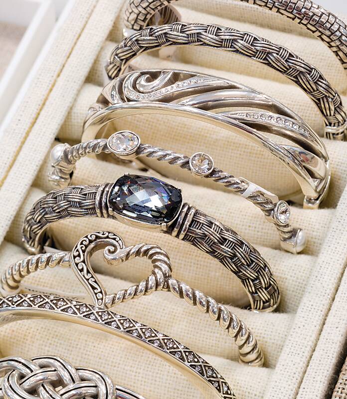 Silver bracelets displayed in a row