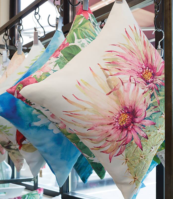 Decorative throw pillows hung from a rack