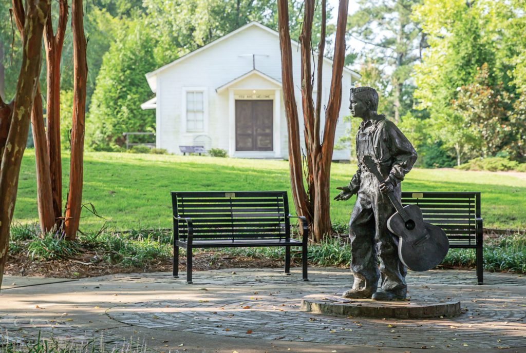 Musician statue by a park bench in Tupelo, Mississippi