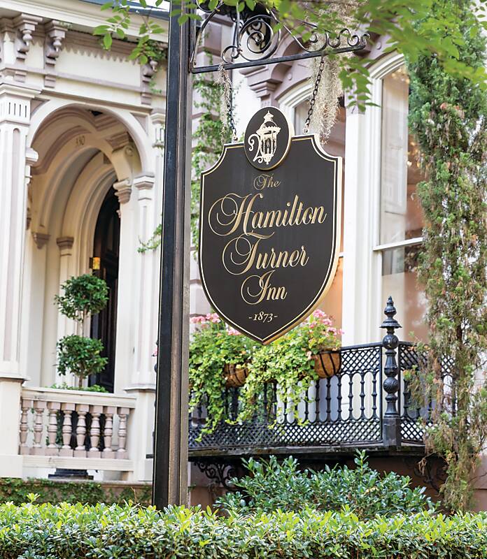 Exterior and hotel sign of the Hamilton-Turner Inn in Savannah, Georgia