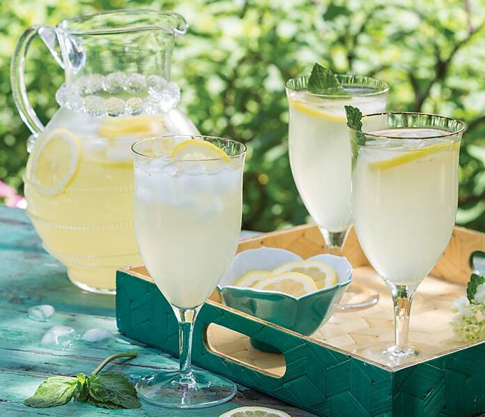 A pitcher and three glasses of lemonade