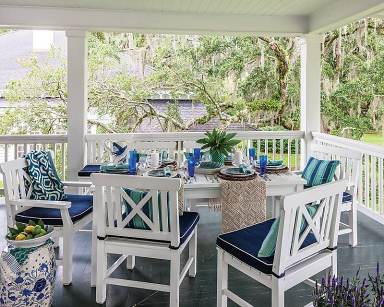 A blue-and-white table setting on a porch