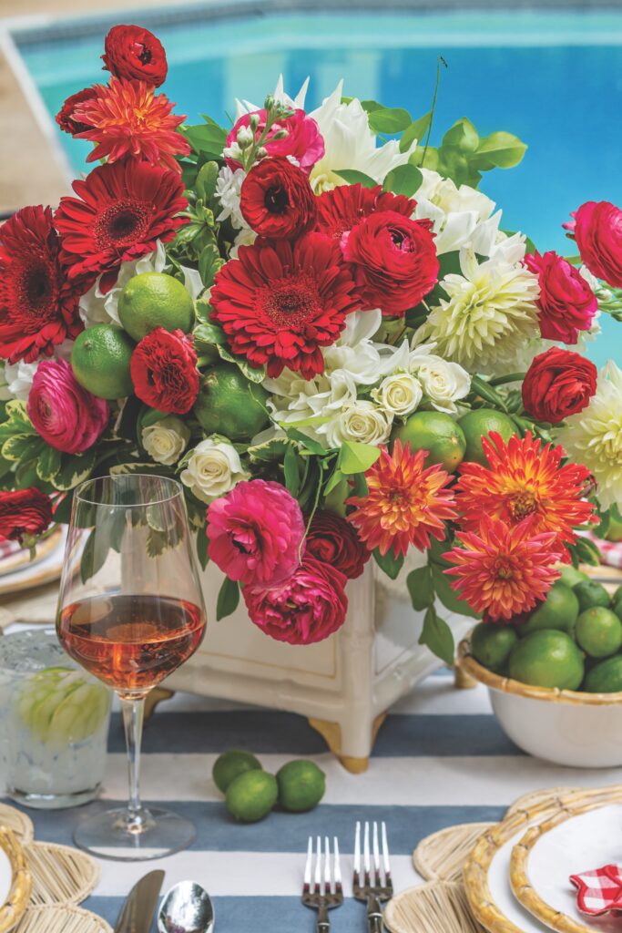 Floral centerpiece of red and white flowers with limes