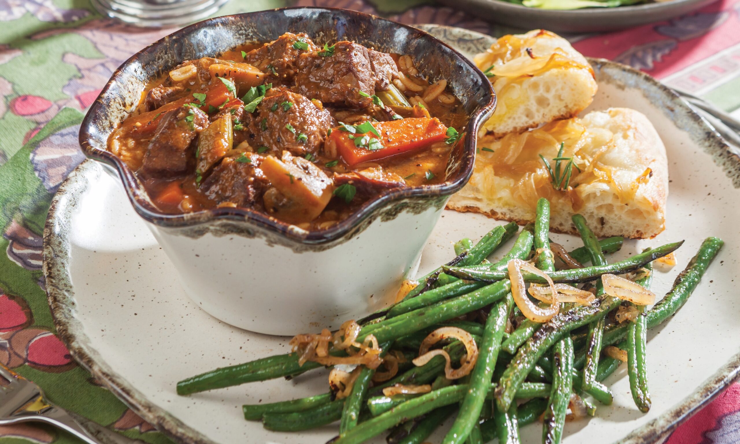Hearty Beef and Barley Stew with a side of focaccia and green beans.