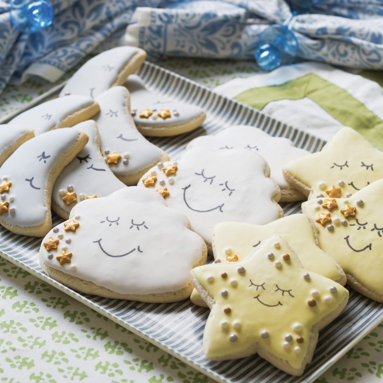Heavenly Sugar Cookies shaped like moons, stars, and clouds with smiling faces