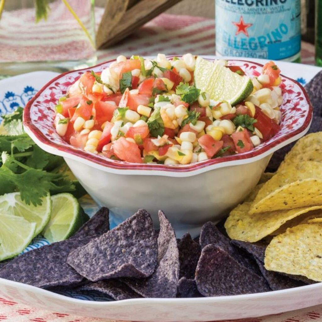 Bowl of corn and tomato salsa with chips