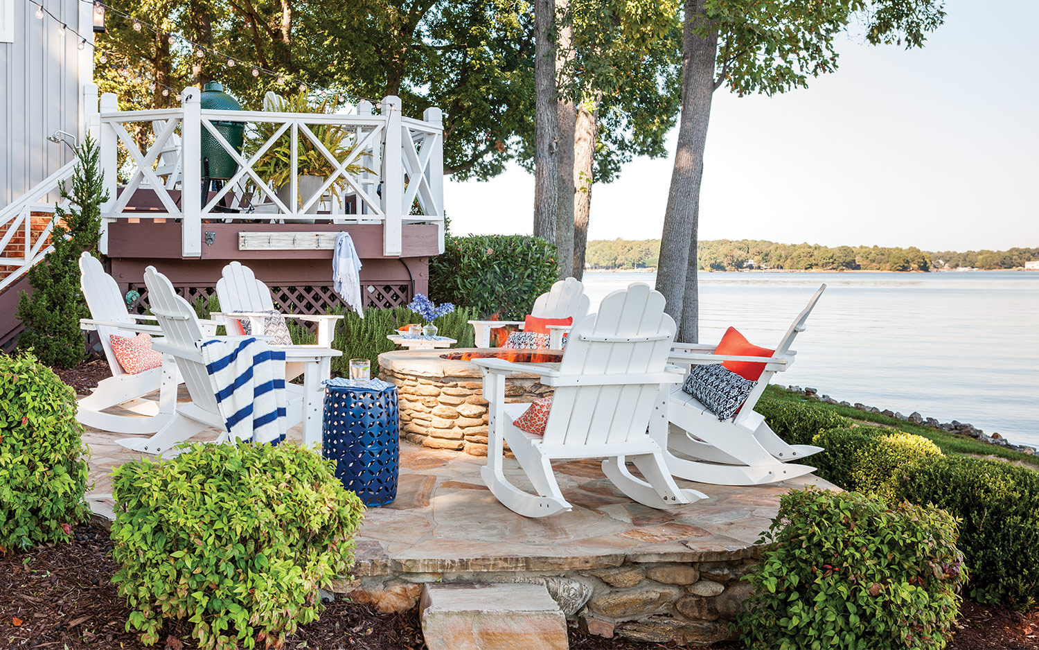 Lakeside patio with white Adirondack chairs
