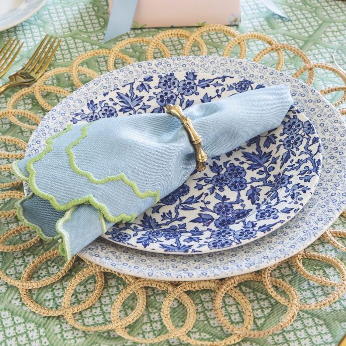 A blue-and-white table setting on a trellis tablecloth