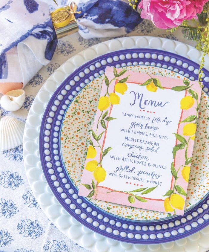 A blue-and-white table setting features a menu