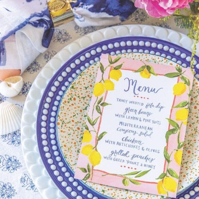 A blue-and-white table setting features a menu