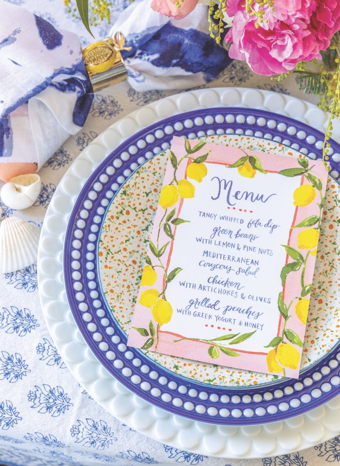 A blue-and-white table setting features a menu