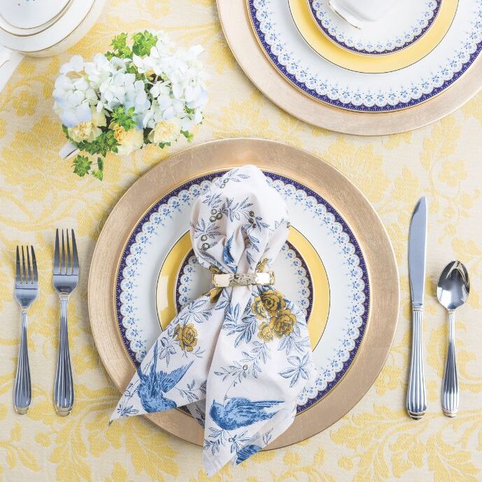 Two place settings with blue, yellow, and white accents