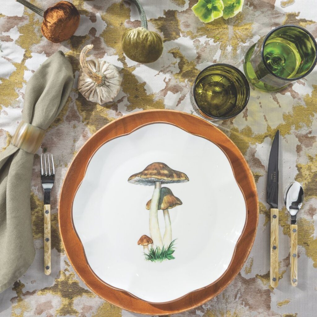 A fall place setting featuring a mushroom motif salad plate