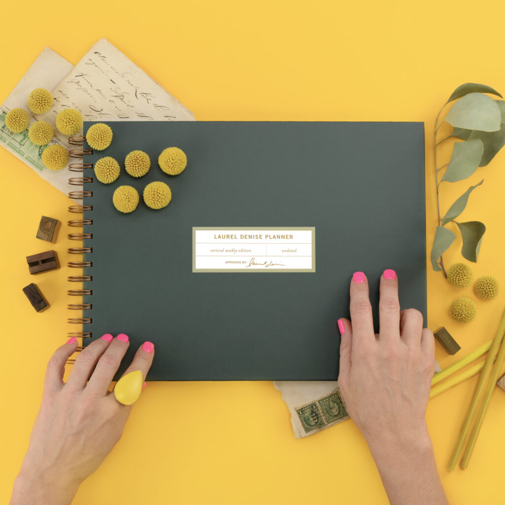 Green planner on a yellow backdrop