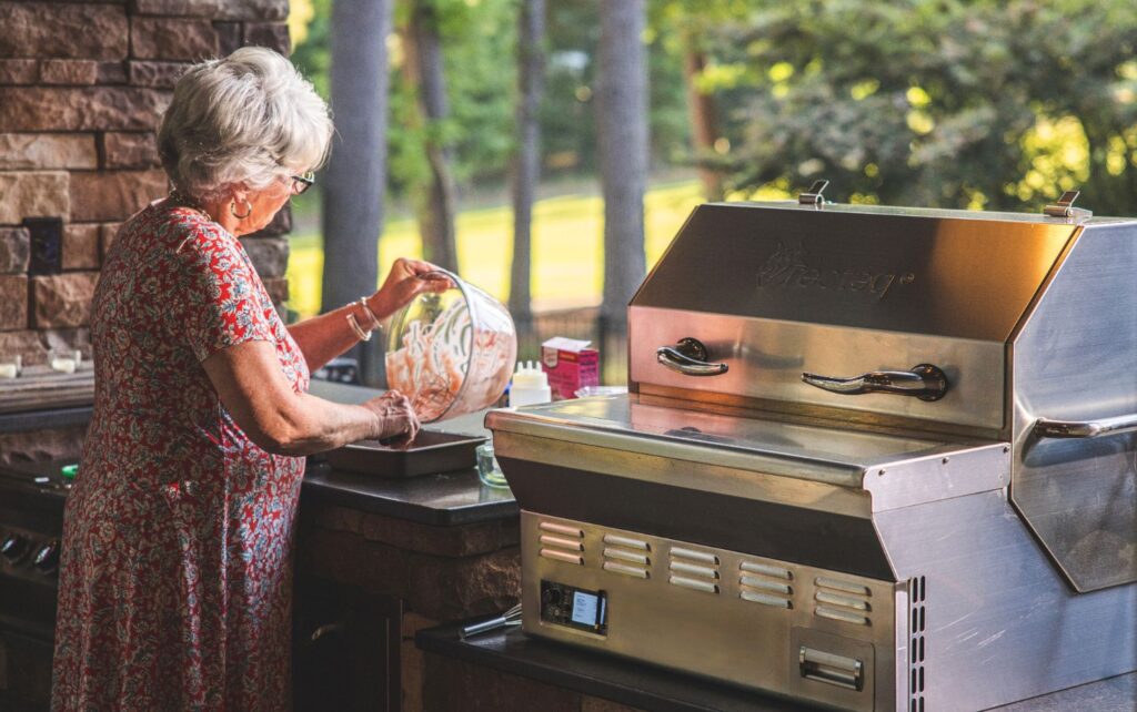 Woman grilling on a shady patio
