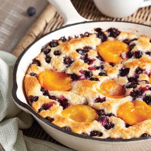 Blueberry-Apricot Cobbler in a white-enamel cast-iron skillet