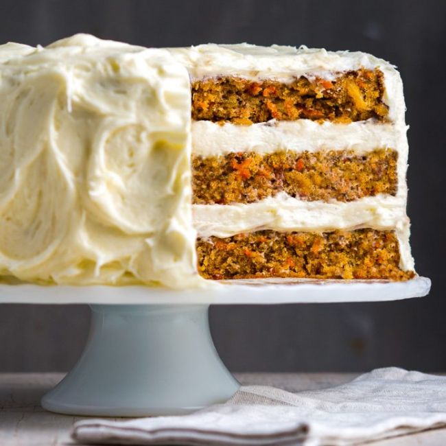 Carrot cake on a pale blue pedestal stand