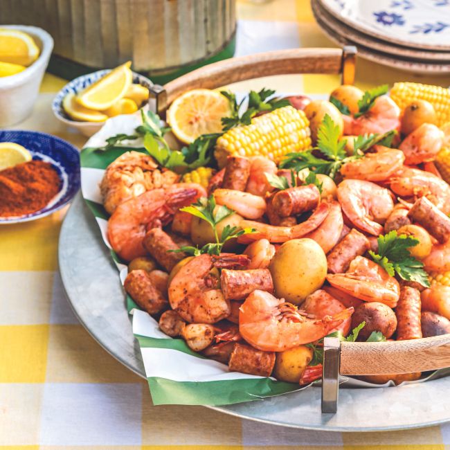 Lowcountry Shrimp Boil served on a platter atop a yellow gingham linen