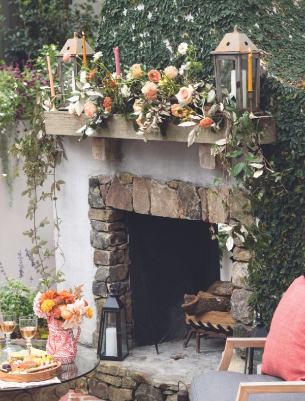 Outdoor fireplace accented with lush florals