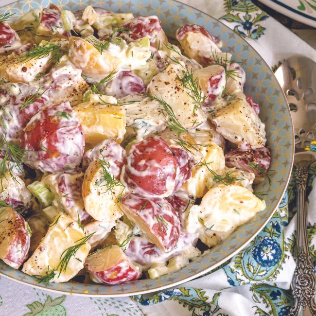 Creamy Dill and Dijon Potato Salad in a light blue bowl