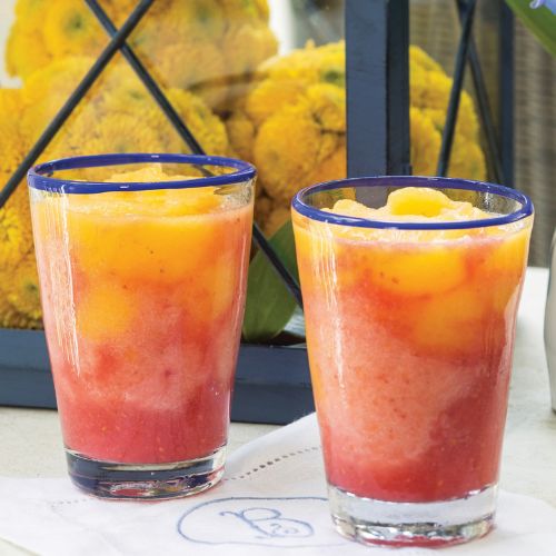 Yellow and pink Sunrise Smoothies in clear glasses 