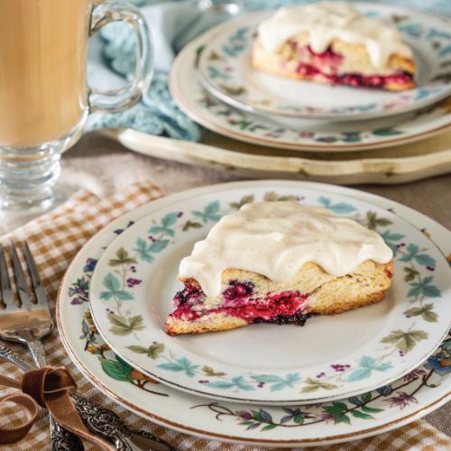 Triple-Berry Scones with Vanilla Bean Glaze on floral china