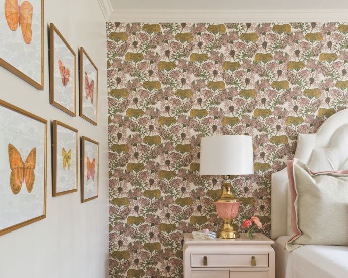 A girl's room with floral wallpaper and framed butterfly prints