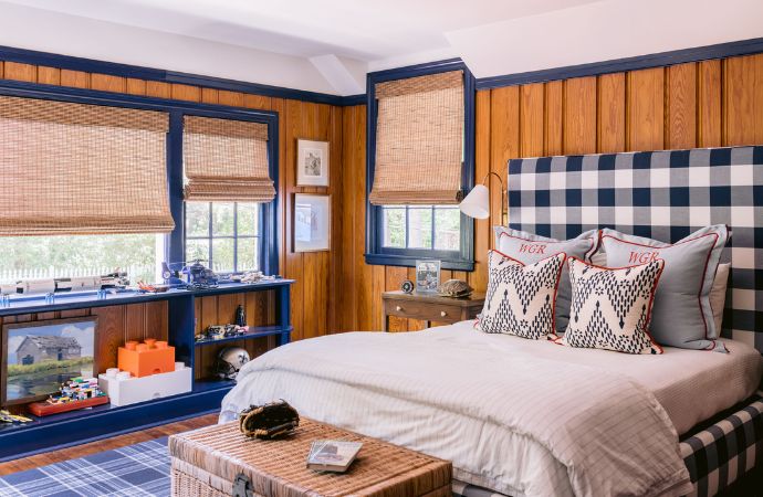 Boyish bedroom with wood paneling and navy accents