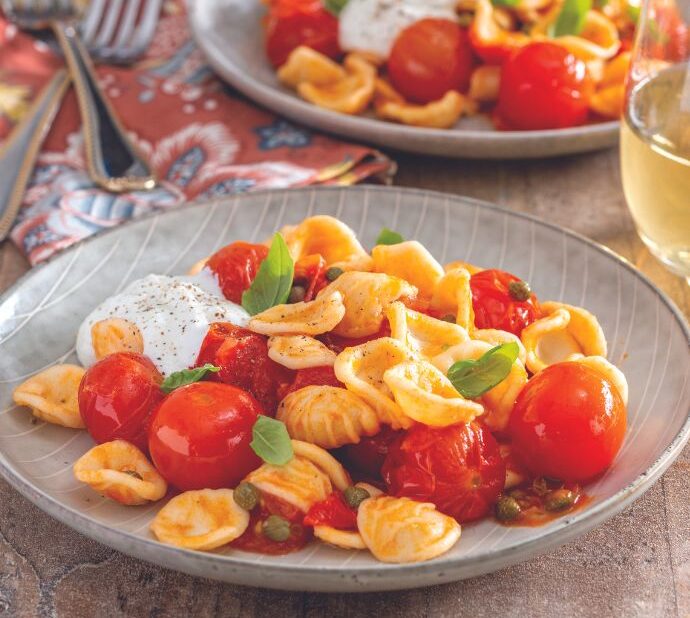 Plated pasta with tomatoes and basil