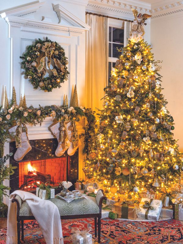 Christmas tree by a garland-draped mantel