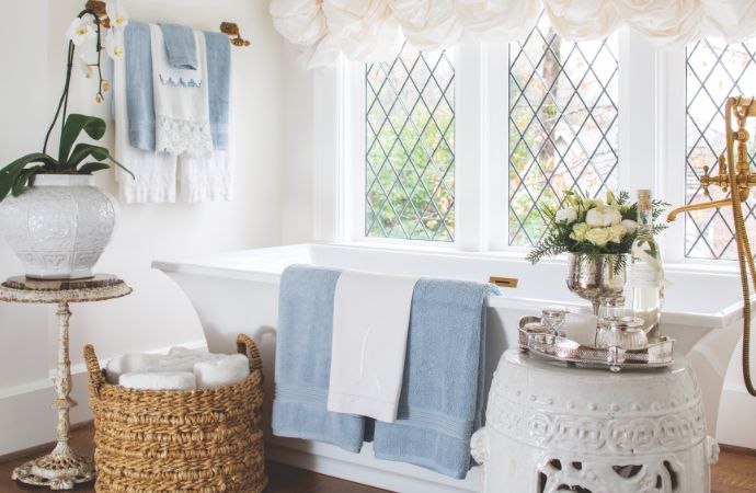 All-white bathroom with blue towels