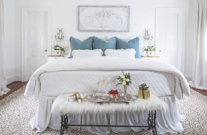 All-white bedroom with blue pillows
