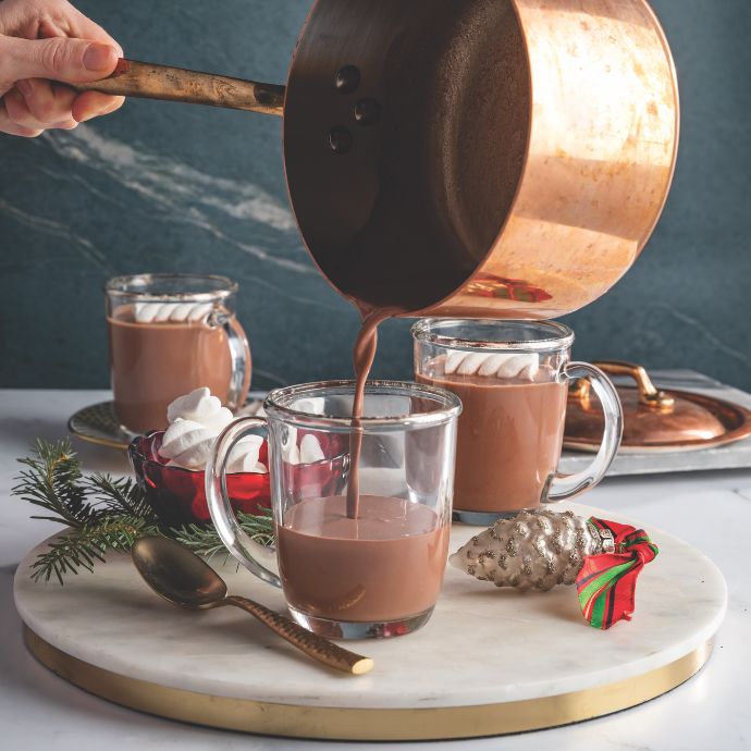 Hot chocolate poured from a copper pot