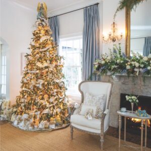 A Christmas tree and floral mantel display lend a living room holiday elegance
