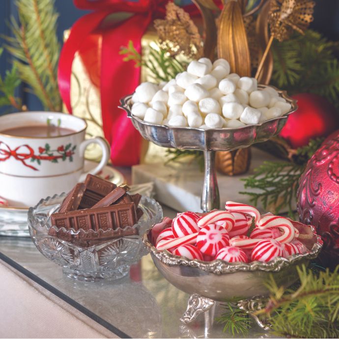 Chocolate bars, marshmallows, and peppermint candies in silver dishes