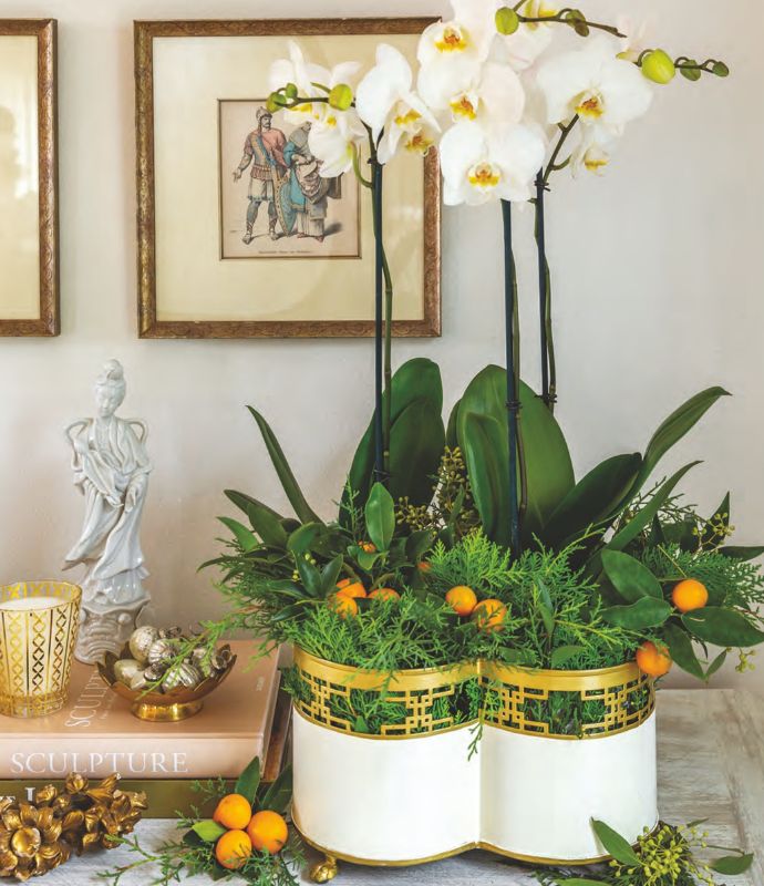 Orchids and kumquats in a white planter