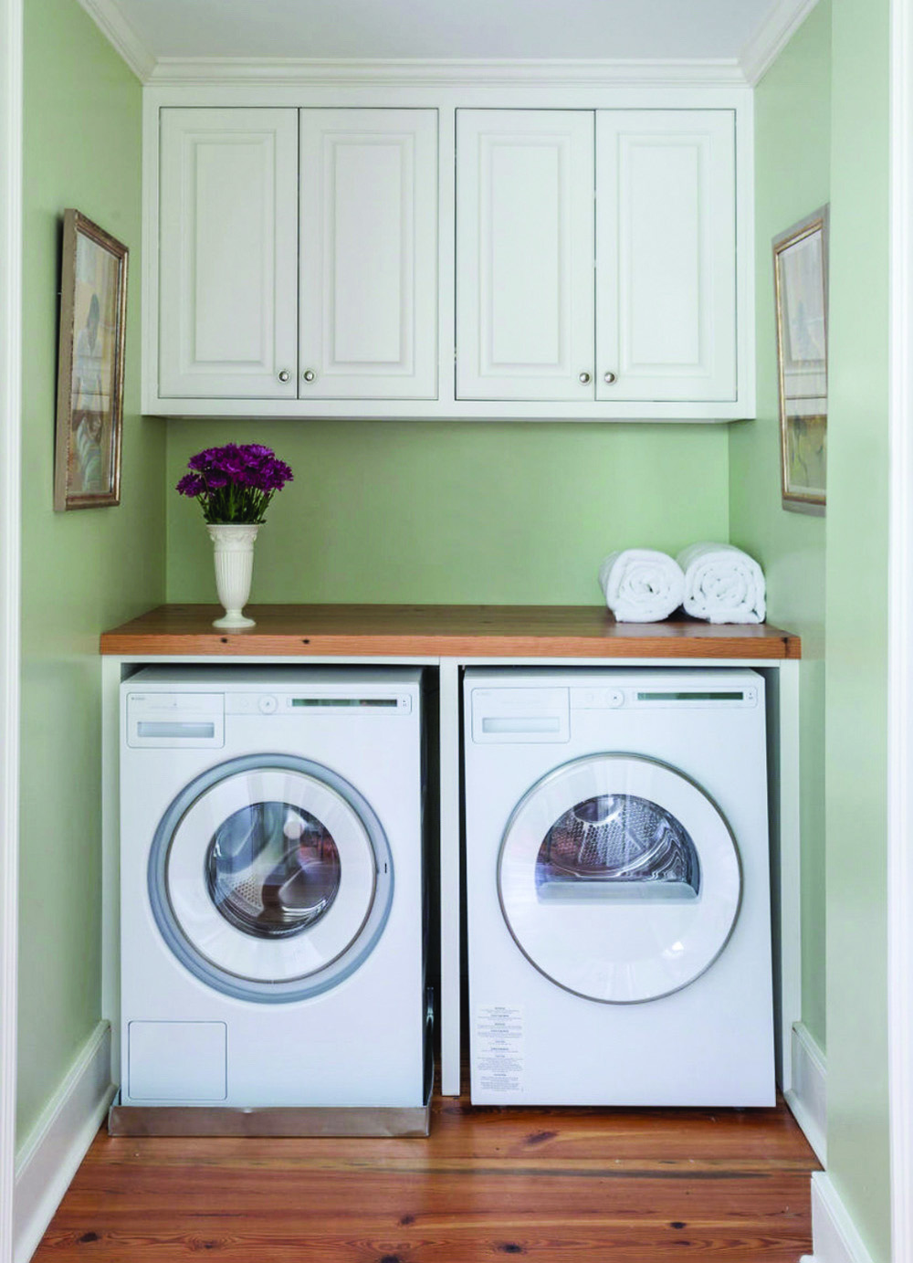 Simple laundry nook with mint green walls