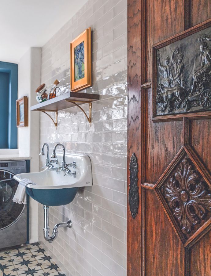 Laundry room with an antique wooden door