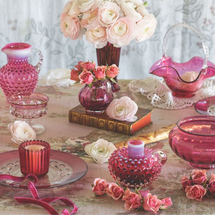 Assorted cranberry glass vessels